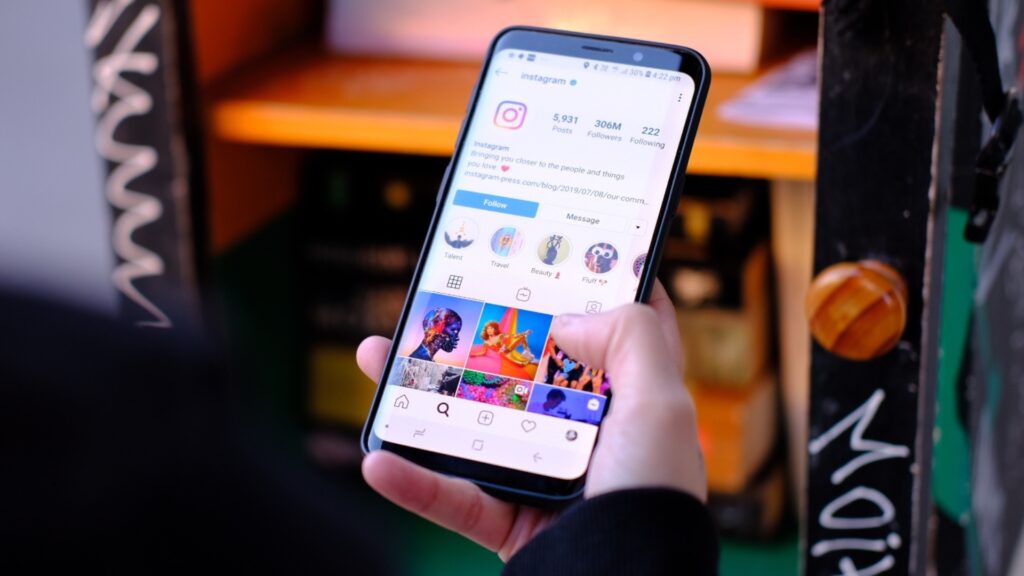 Rise of Short Form Marketing "Person browsing Instagram on a smartphone, highlighting the impact of Reels and short-form videos in the Rise of Short Form Marketing era, where quick, engaging content drives modern brand communication and audience connection."